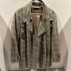 A stripped black and blue and white short luxury trench coat .